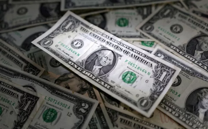 Dollar buoyant; yuan wobbles after China cuts lending benchmarks