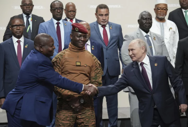 Putin woos African leaders at a summit in Russia with promises of expanding trade and other ties