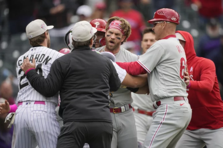 Phillies' Bryce Harper ejected after charging Rockies dugout