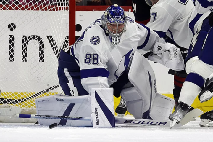 Vasilevskiy wins his season debut and Brayden Point has a hat trick as Lightning beat Hurricanes 8-2