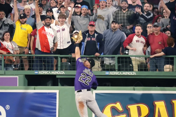 Rockies beat sloppy Red Sox 4-3 in 10 after rain delay