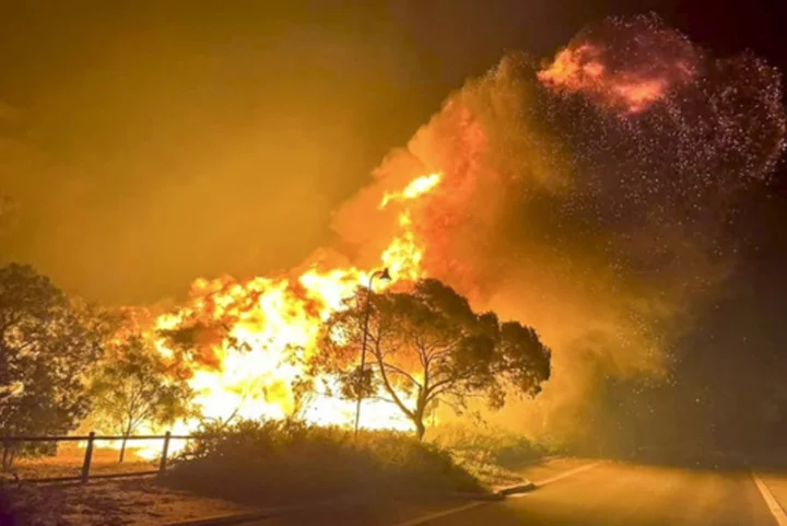 Dozens evacuate and 10 homes are destroyed by a wildfire burning out of control on the edge of Perth